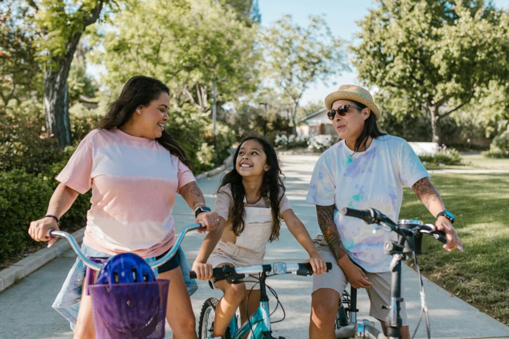 Family enjoys a sunny day riding bicycles in a park, fostering happiness and togetherness.